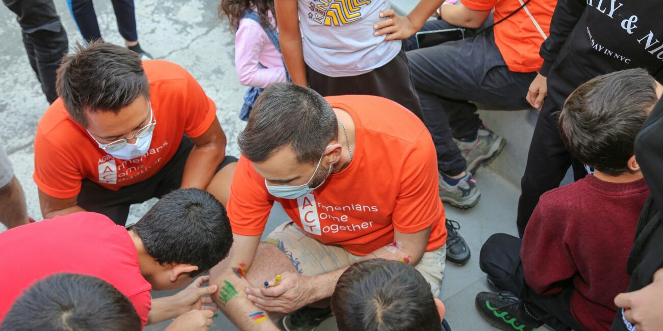 Volunteers playing with children in Sevan
